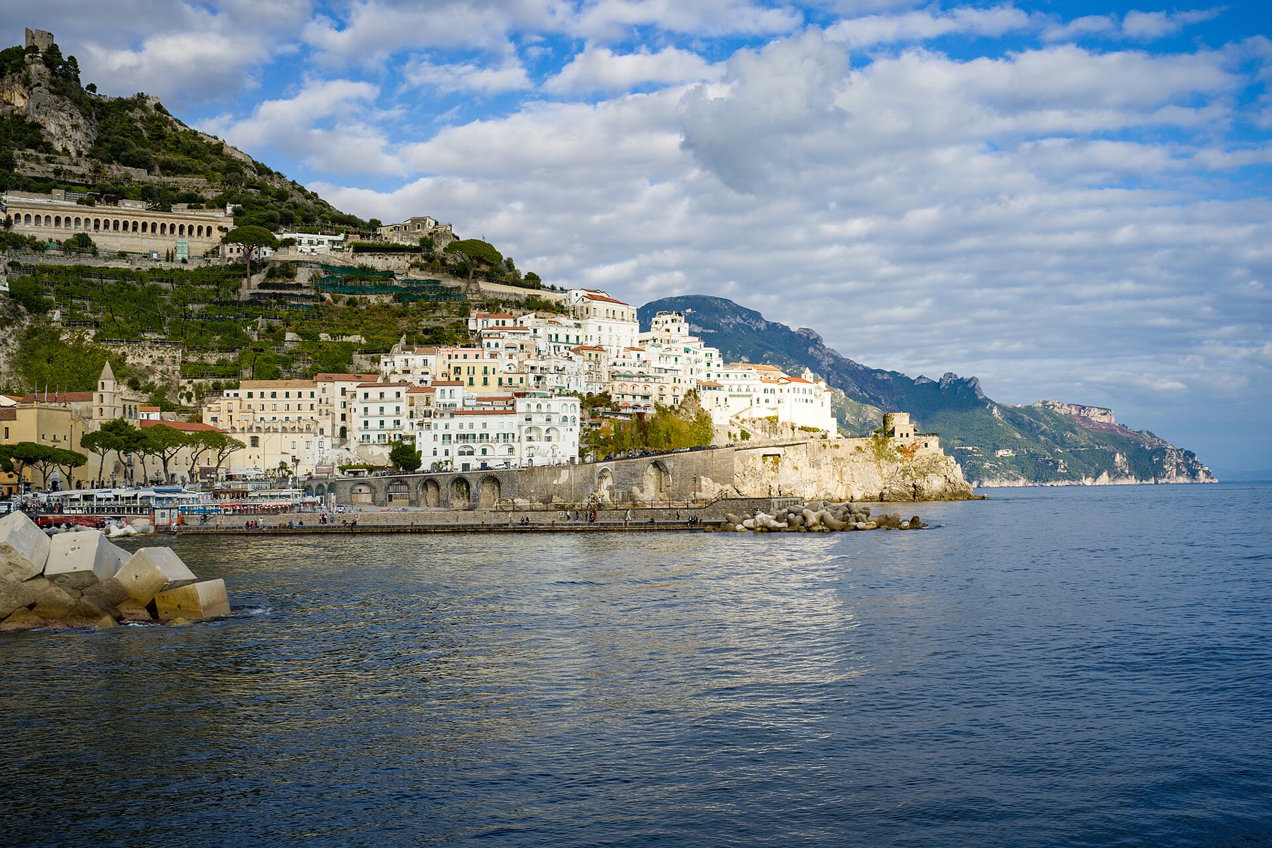 Amalfi Coast towns seen from the sea under clear Mediterranean light, the proportion love after loss romance books need from Italy