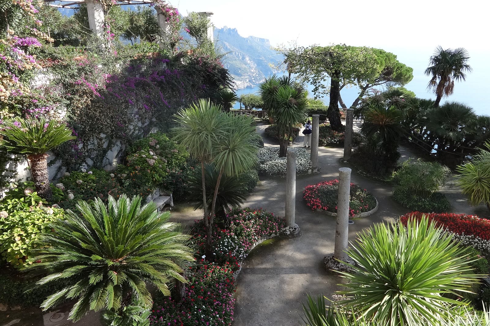 Sunlit terrace garden at Villa Rufolo in Ravello, palms and paths above the Amalfi Coast, the walking weather of Ravello romance