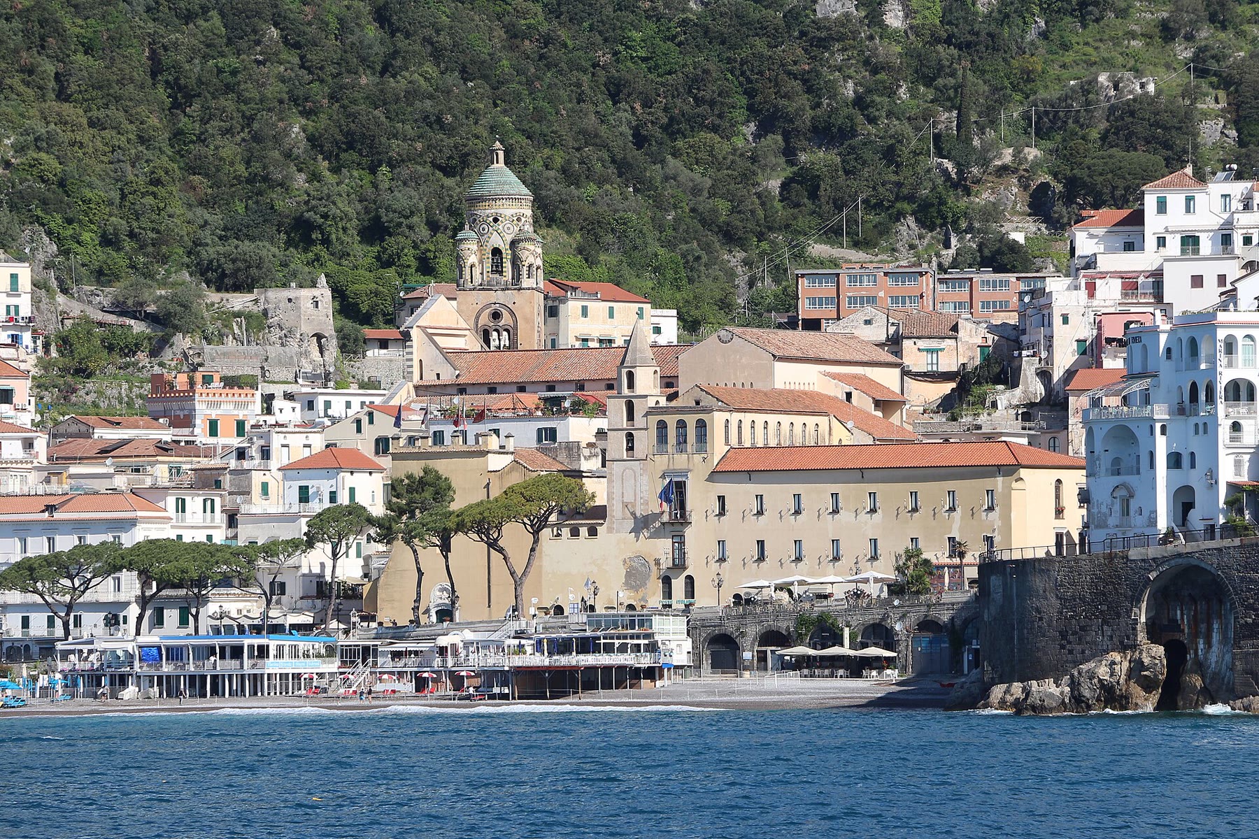 Amalfi town square below the Duomo with shared tourist density and Campania cathedral climate still named