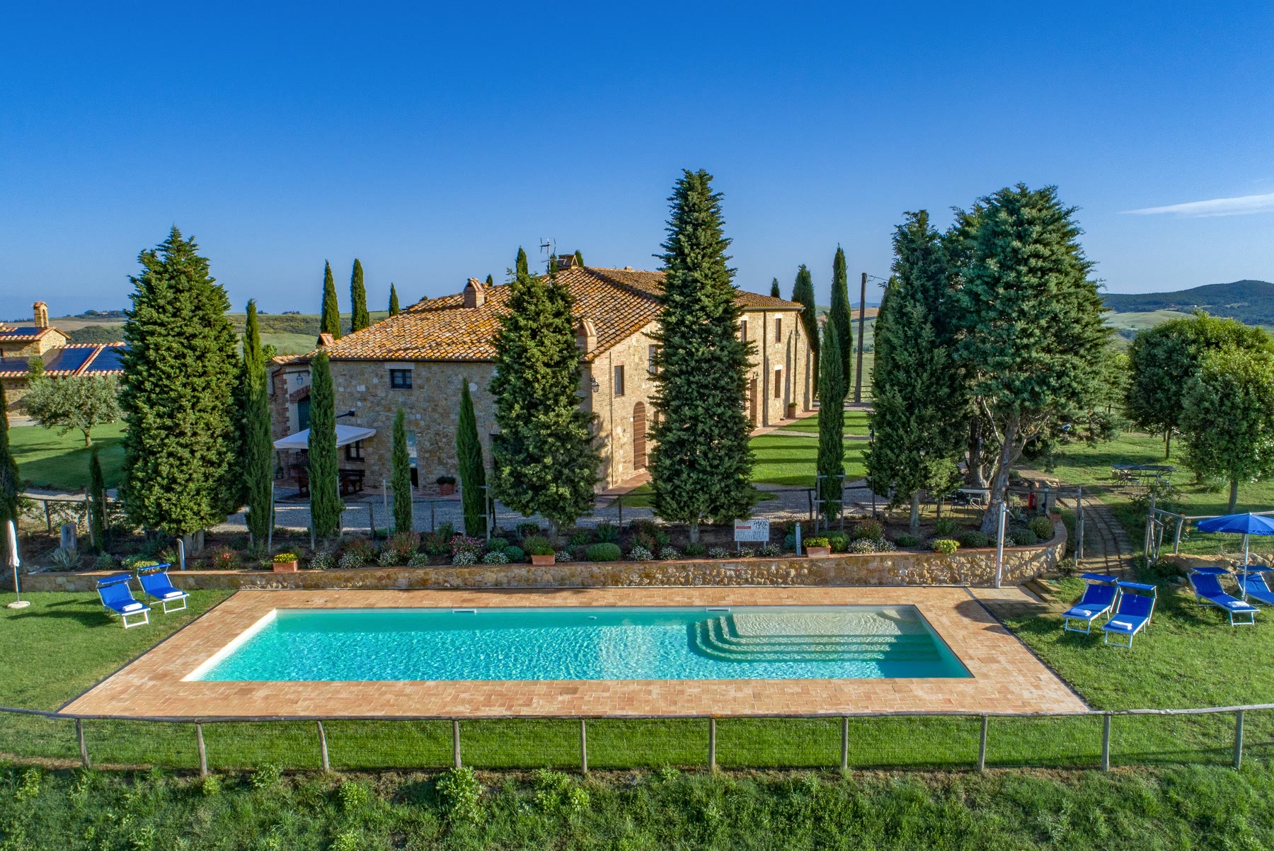 Italian agriturismo romance working-farm stay climate with Val d Orcia panorama still named