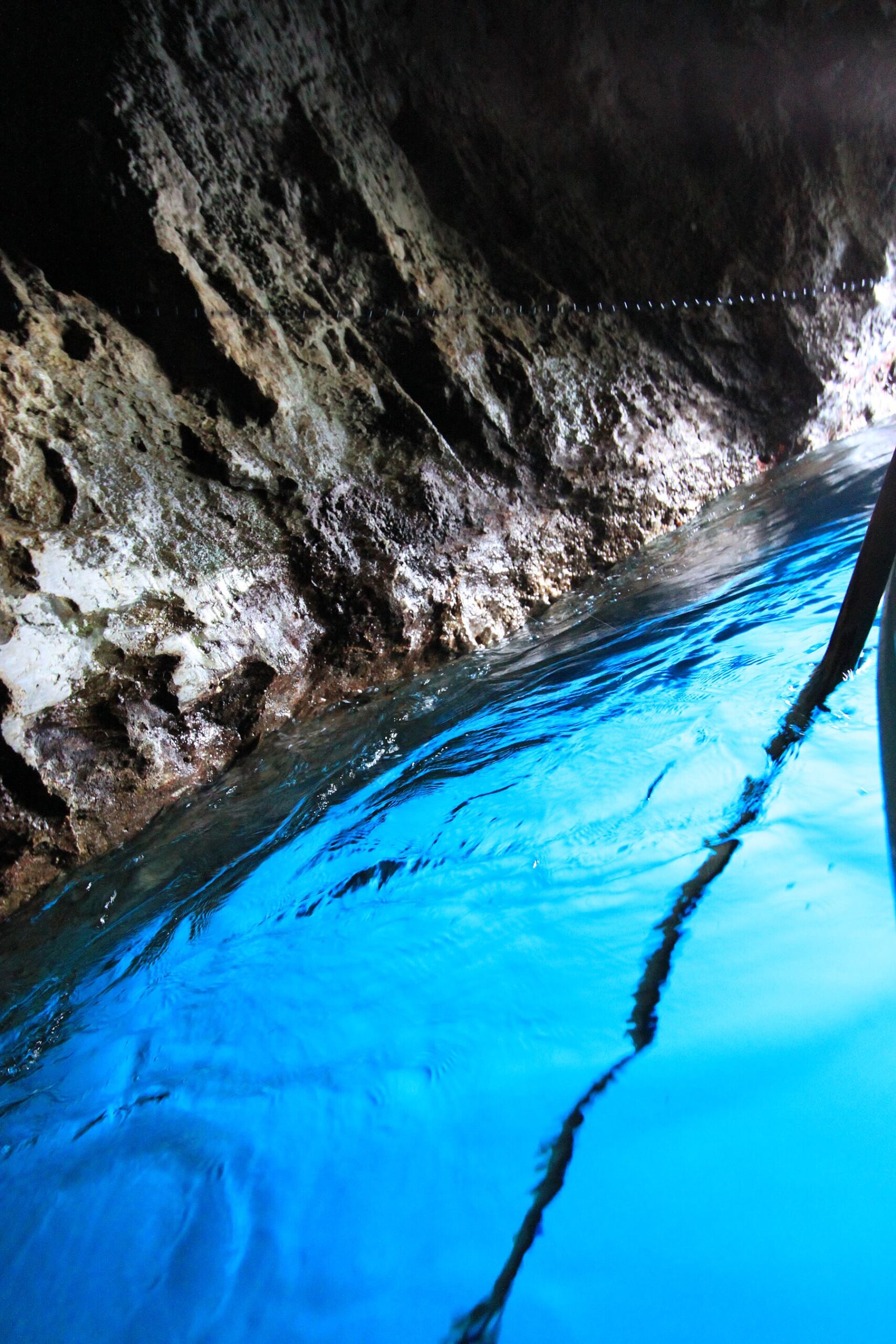 Entrance wait for Capri Blue Grotto for romance readers with boat-cave climate still named