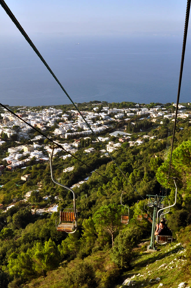 Capri chairlift open seats above Anacapri for romance readers with Monte Solaro honesty still named