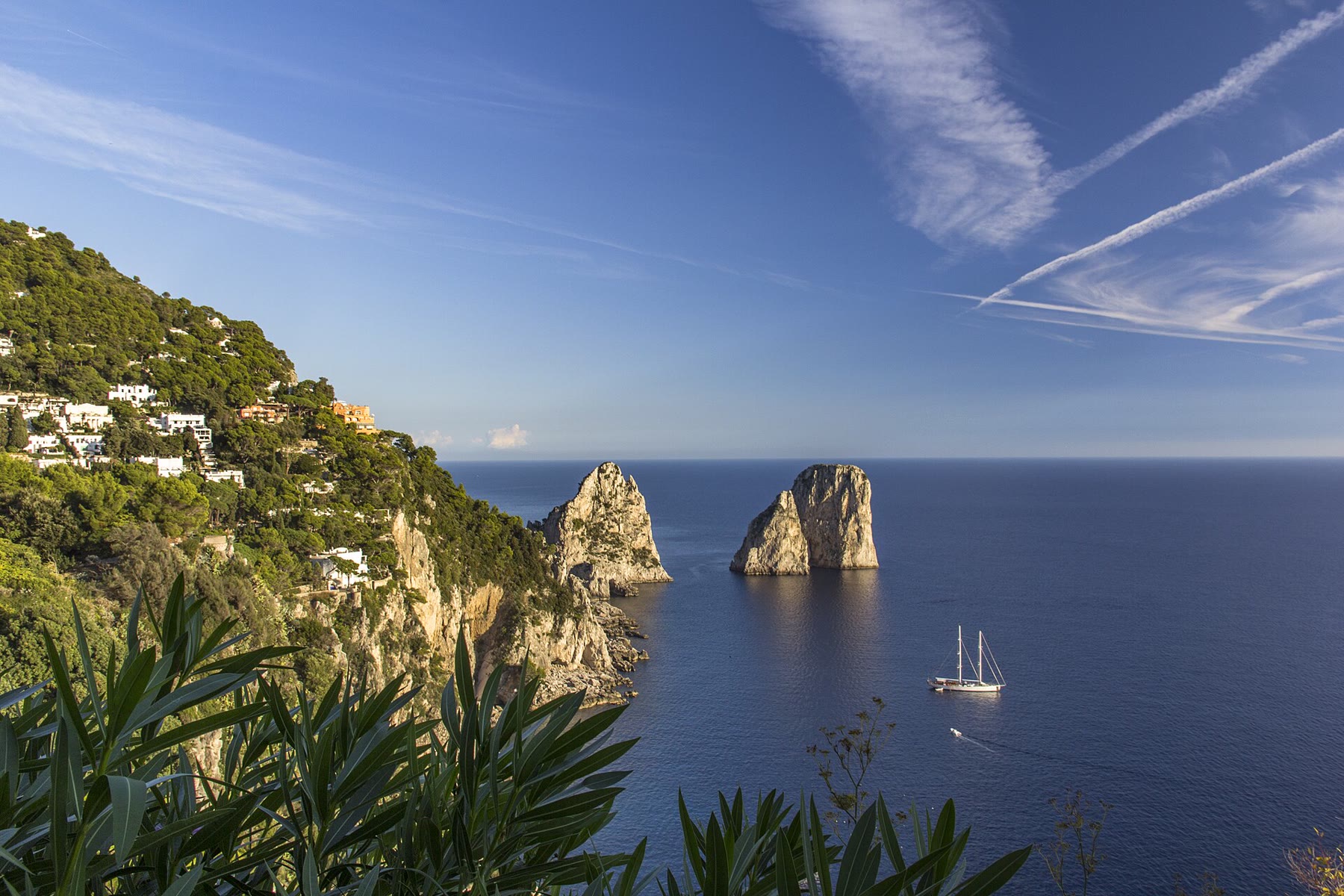 Boat approach to Capri Faraglioni for romance readers with sea-stack climate still named