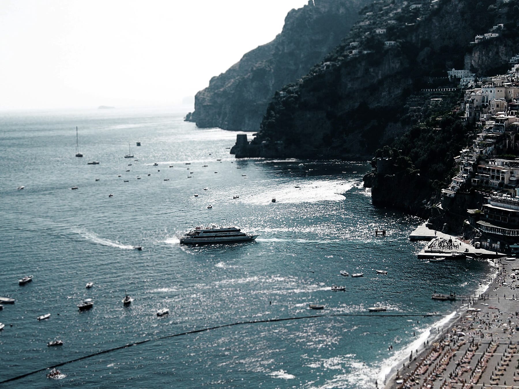 Positano cliff stack above the harbor for romance readers with working-harbor climate still named