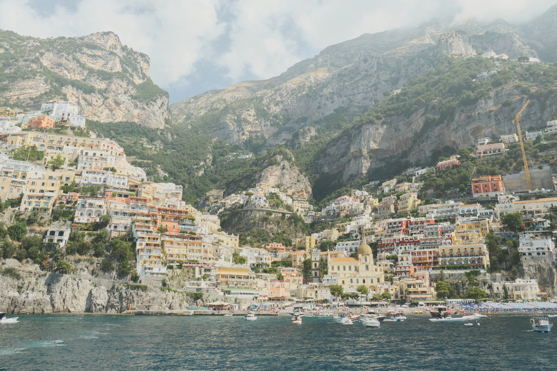 Positano houses stacked above the bay, vertical town for Positano romance and Amalfi Coast romance readers